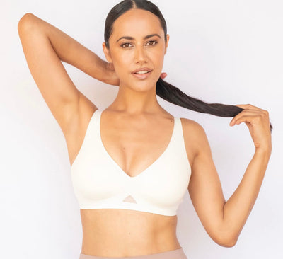 model poses wearing white t shirt bra front view in uae